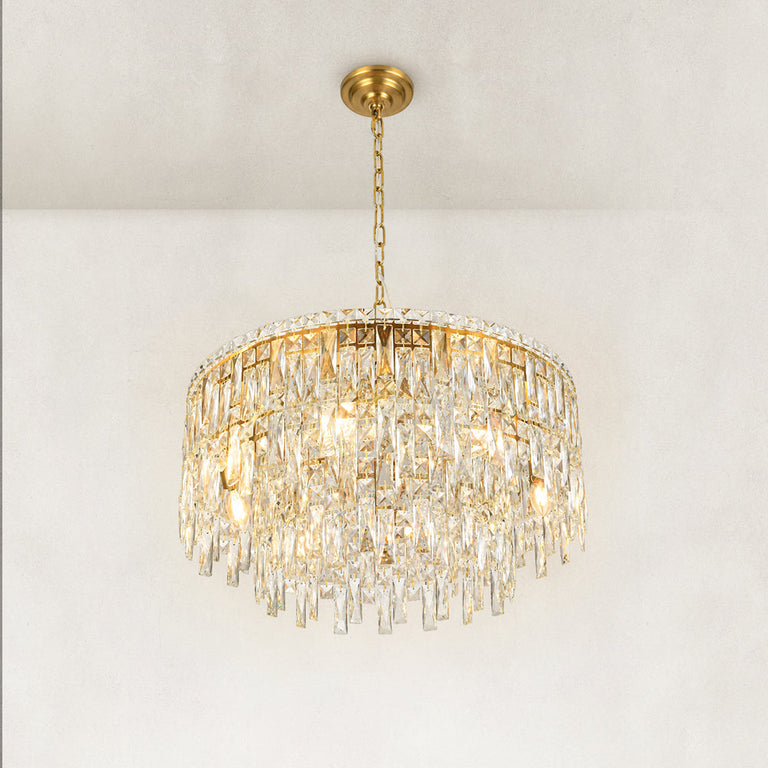 Gold-tone tiered crystal chandelier, complete fixture illuminated lower angle