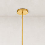 Glass drum chandelier, gold-tone ceiling canopy and rod close view.