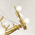 Illuminated chandelier globe on antler branch close view