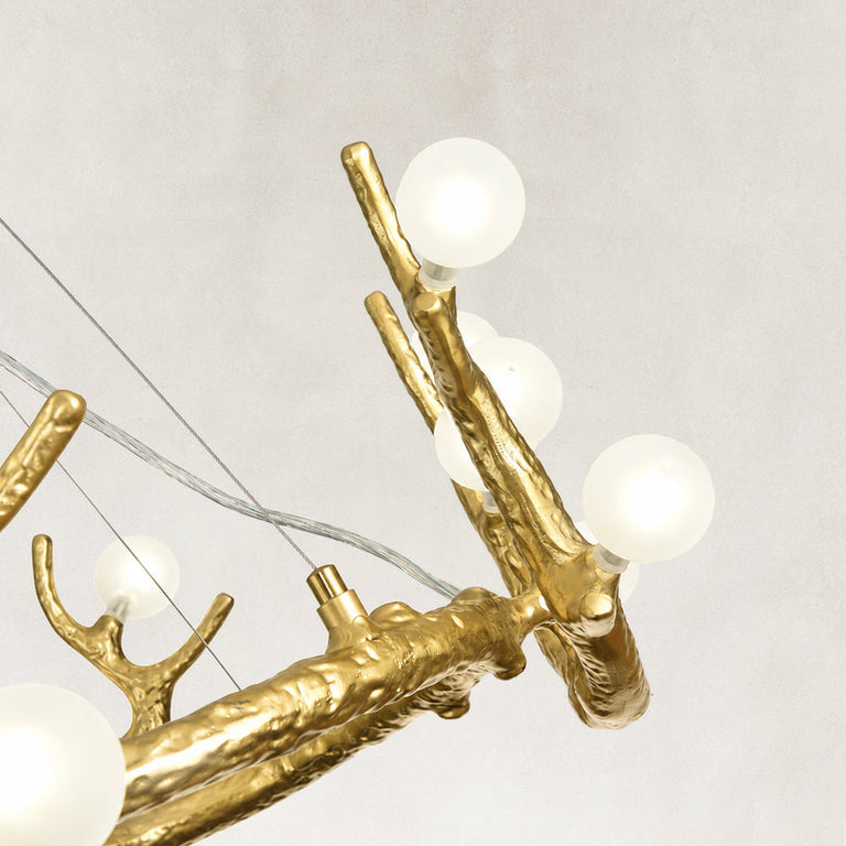 Illuminated chandelier globe on antler branch close view