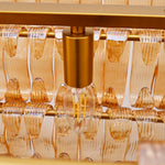 Lamp-holder detail inside the amber glass chandelier.