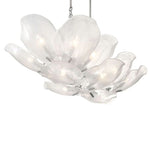 Elongated white glass petal chandelier with silver-tone details seen at an angle.