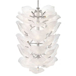 Tall white glass petal chandelier seen from below at an angle.