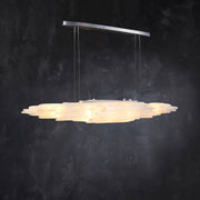 Angled illuminated selenite linear pendant with a silver-tone canopy.