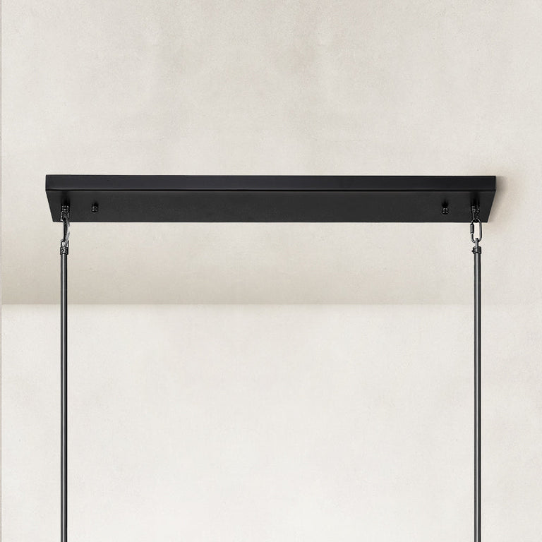 Linear glass-tube chandelier, black linear canopy and rods.