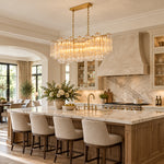 Linear tiered glass chandelier above a kitchen island