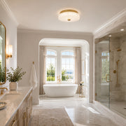 Low-profile textured glass flush mount shown in a bathroom interior