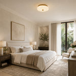 Low-profile textured glass flush mount in a bright bedroom