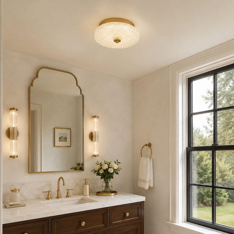 Low-profile textured glass flush mount above a vanity area
