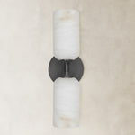 black twin-cylinder wall sconce shown unlit.