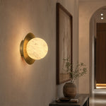 Eclipse Orb Curved Brass Disc Alabaster Wall Sconce by Dalmivik, complete fixture view