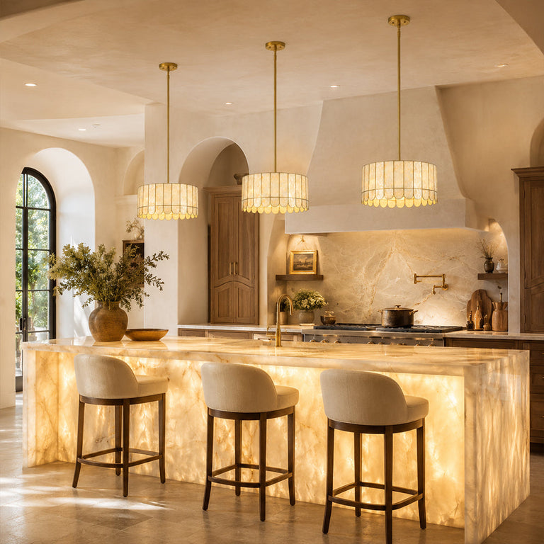 Scalloped single-tier drum pendants above illuminated stone island