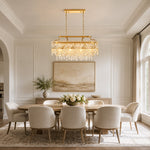 Gold-tone oval crystal chandelier, bright dining room.