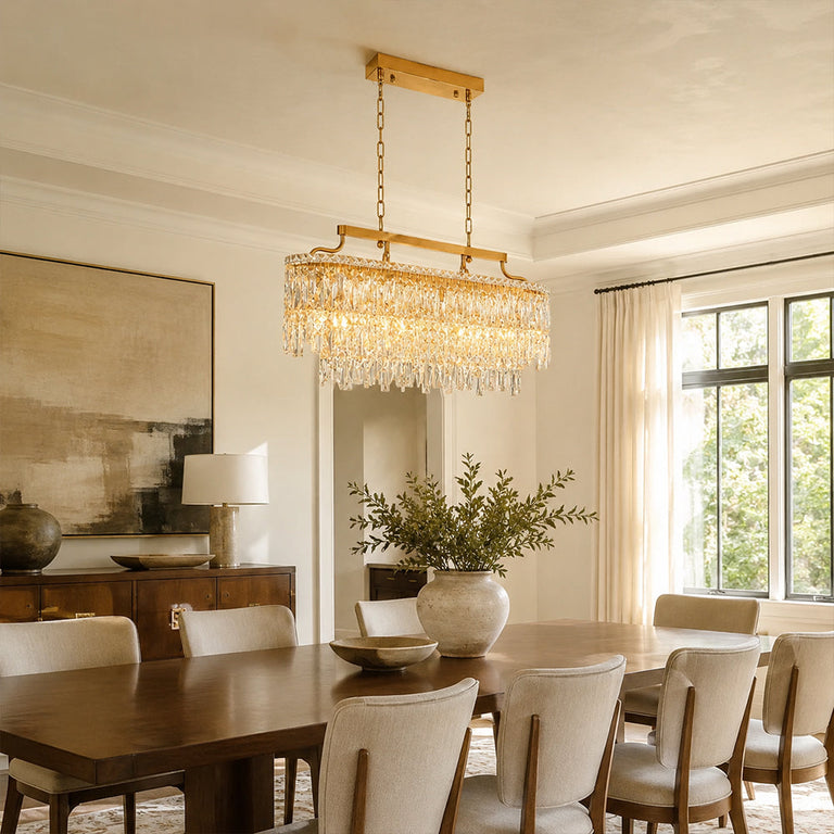 Gold-tone oval crystal chandelier, window-corner dining room.
