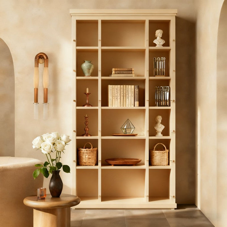 Off-white U-shaped wall sconce beside a living-room bookcase.