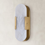 Unlit oval alabaster wall sconce with brass-tone hardware.