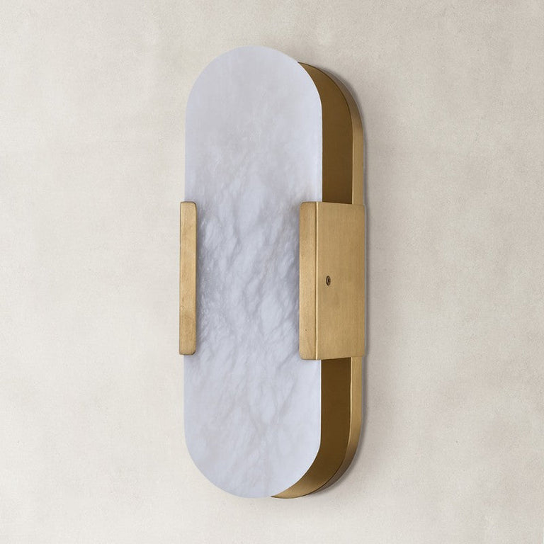 Unlit oval alabaster wall sconce with brass-tone hardware.