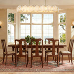 Petal Oval LED Chandelier in brass finish, shown in a bright dining room