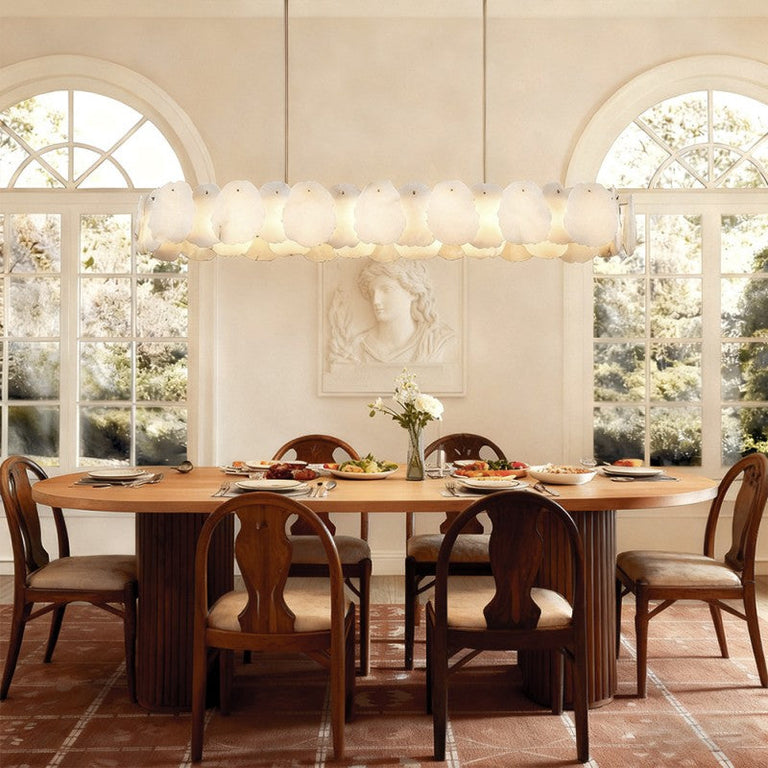 Petal Oval LED Chandelier in brass finish, shown above a dining table