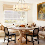 Petal Round LED Chandelier, 24 in in brass finish, shown above a dining table