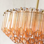 Stepped tube-glass chandelier, amber tubes and brass-tone top rim.