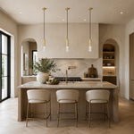 Brass ribbed glass mini pendants over a kitchen island