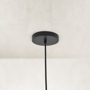 Matte-black ceiling canopy and suspension detail