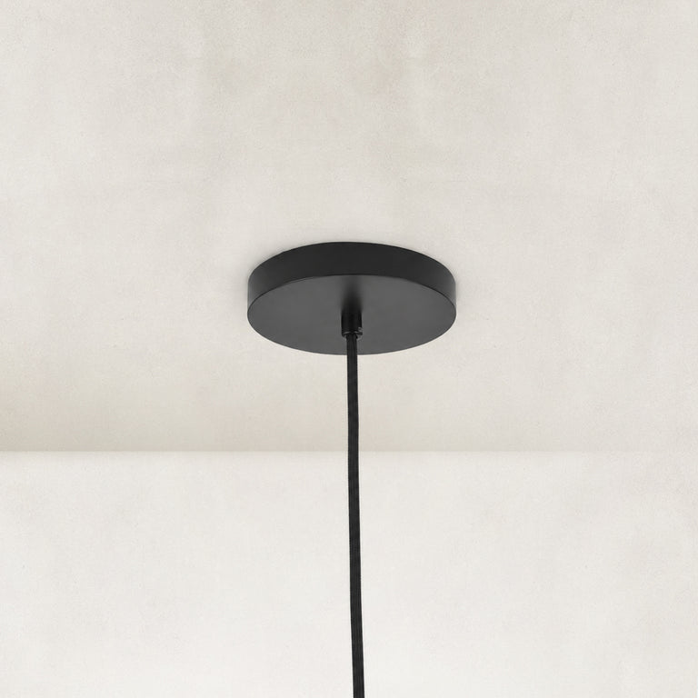 Matte-black ceiling canopy and suspension detail