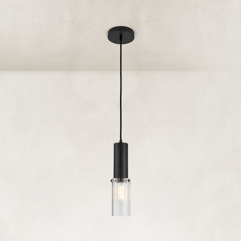 Matte-black ribbed glass cylinder mini pendant shown as a complete fixture