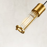 Angled detail of the brass ringed ribbed glass mini pendant