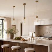 Brass ringed ribbed glass mini pendant above a kitchen counter