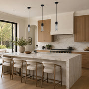 Matte-black ringed ribbed glass mini pendant above a kitchen counter