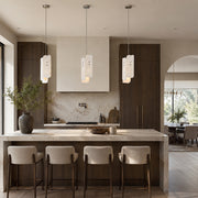 Rounded Four-Panel Marble Pendant displayed in a furnished interior