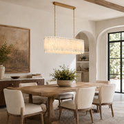 Scalloped White Marble Island Pendant displayed in a furnished interior