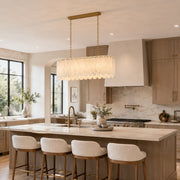 Scalloped White Marble Island Pendant installed above a kitchen island