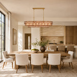 Linear amber glass chandelier room scene.