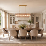 Smoke glass sculpted linear island chandelier above a contemporary dining table