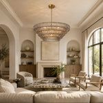 Smoke tiered-glass chandelier in an arched-alcove living room.