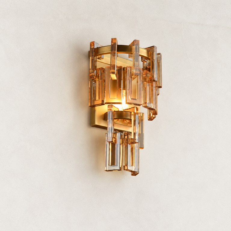 Amber crystal wall sconce with Brass-finish hardware, shown as a complete fixture