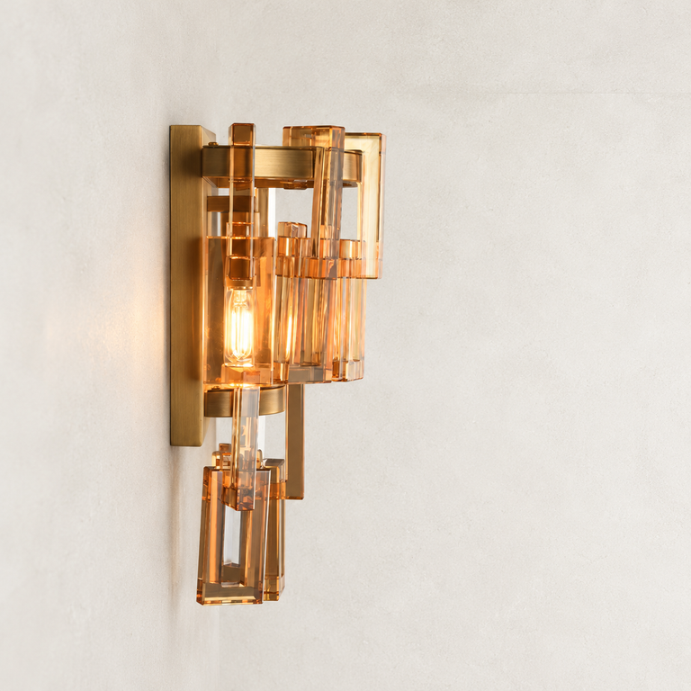 Amber crystal wall sconce with Brass-finish hardware, shown as a complete fixture