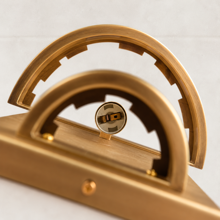 Curved brass-finish frame detail on the crystal wall sconce