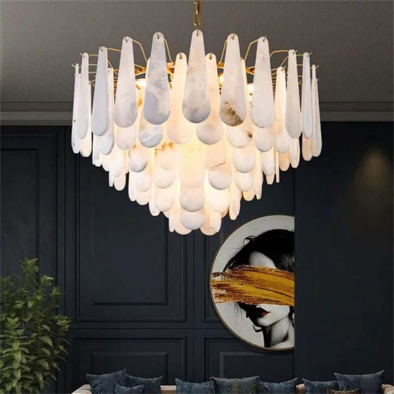 Illuminated alabaster chandelier in a furnished interior with a dark paneled wall.
