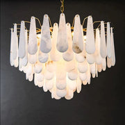 Illuminated chandelier with overlapping alabaster teardrop panels against a neutral background.