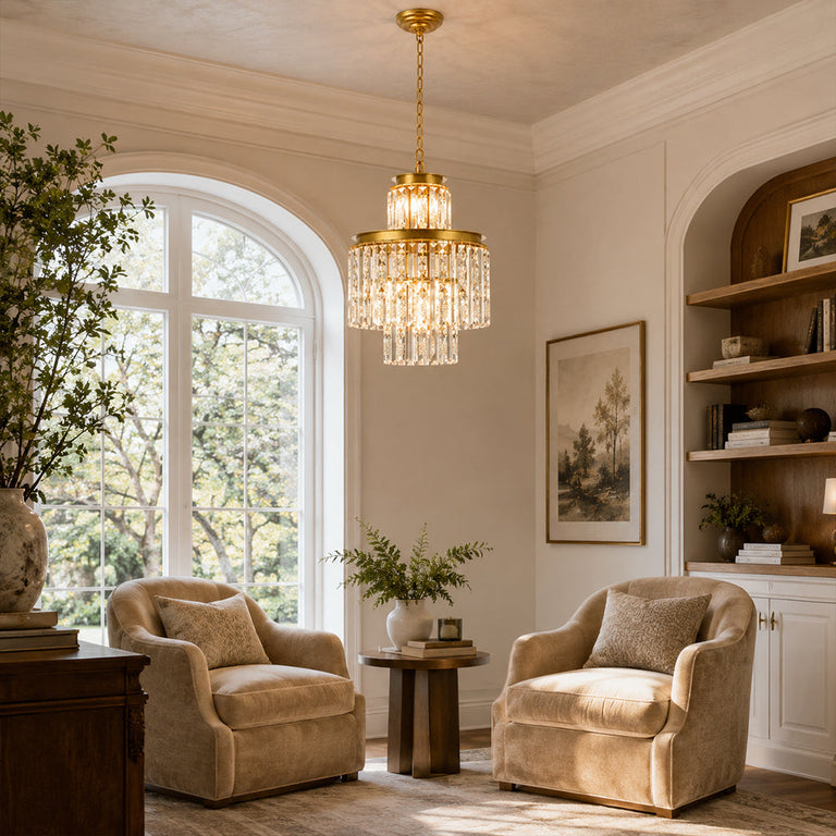 Compact crystal drum chandelier above a round side table between two armchairs.