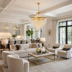 Tiered crystal drum chandelier in a bright living room beside an open kitchen.