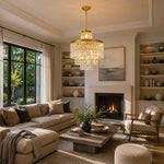 Crystal drum chandelier above a dark coffee table in a windowed living room.