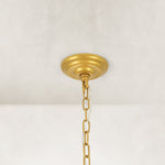 Crystal drum chandelier, round gold-tone ceiling canopy and chain.