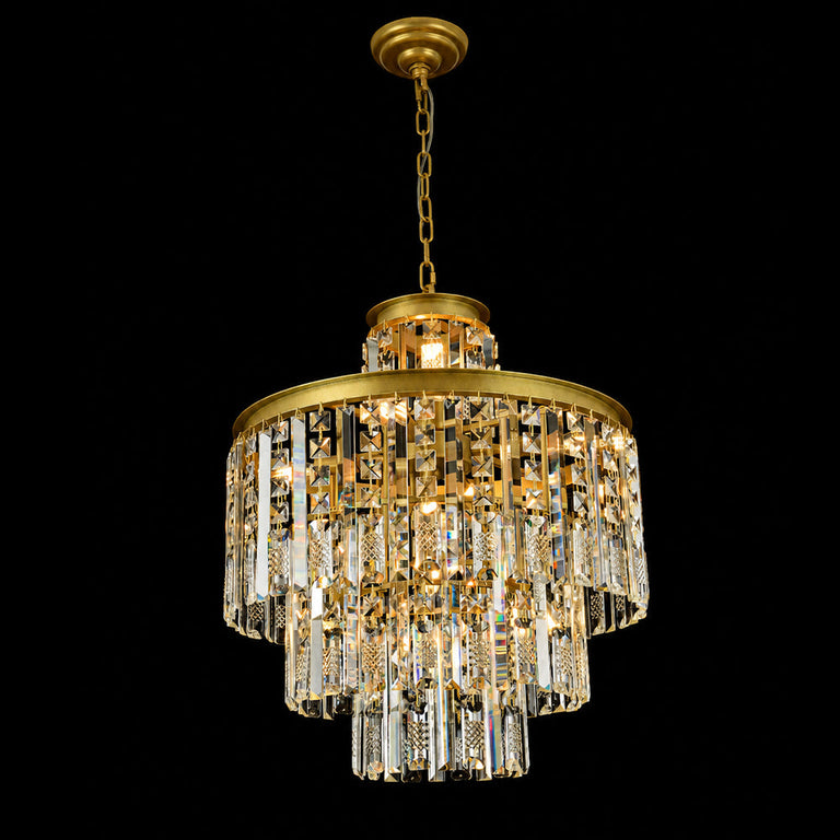 Gold-tone crystal drum chandelier illuminated on a dark background.