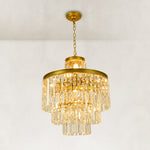 Illuminated crystal drum chandelier, complete angled view with chain.