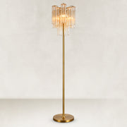 Tall floor lamp with a tiered glass tube shade, gold-tone stem and round base.